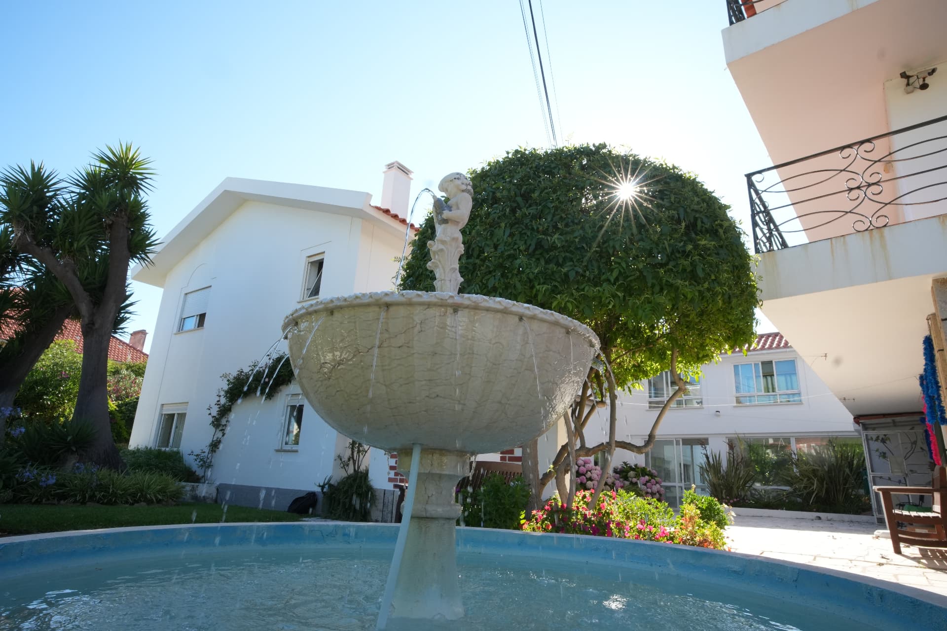 The British Retirement Home residence with its garden fountain in the foreground