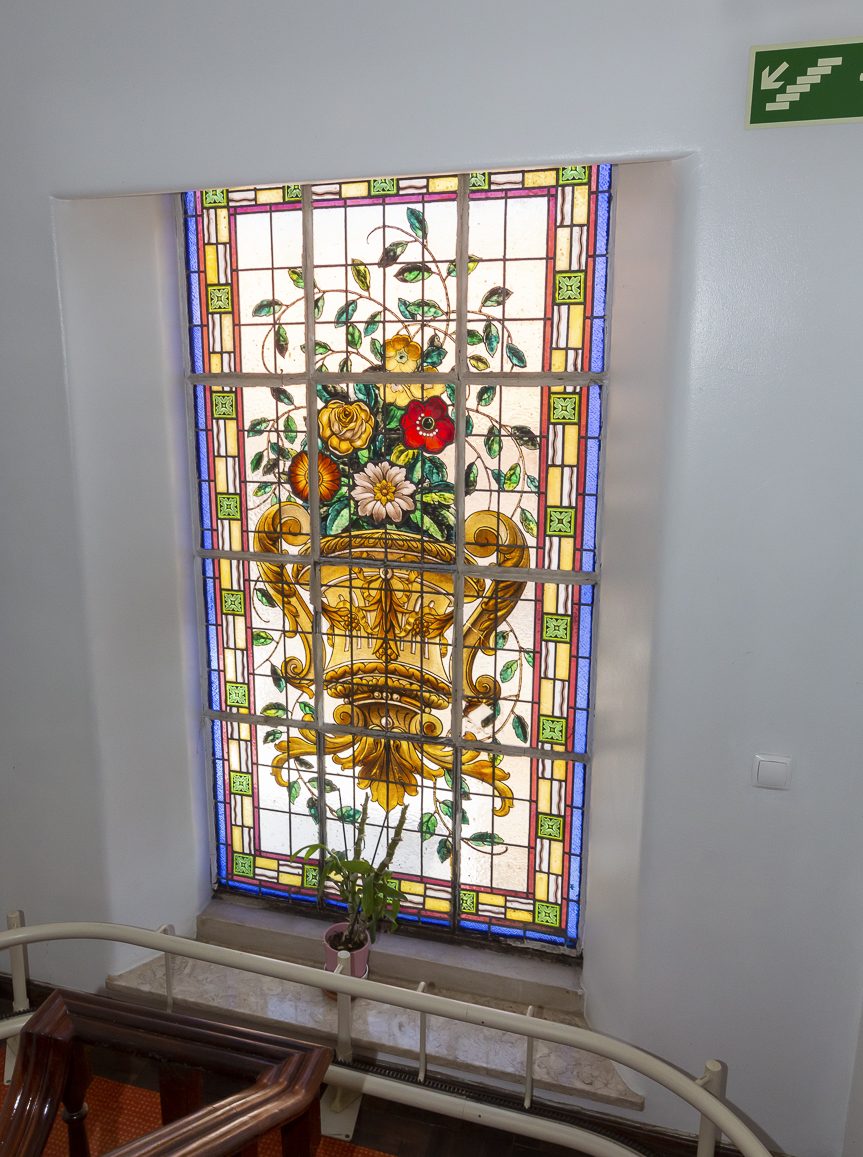 The original stained-glass window on the staircase landing